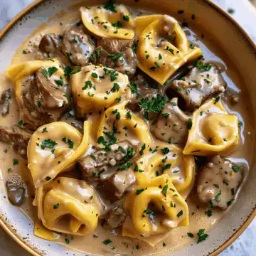 Buttery Steak Tortellini in Slow-Cooked Southern Garlic Cream Recipe taken with iphone 15 pro max --iw 2 --ar 4:5 --v 6.0 --raw