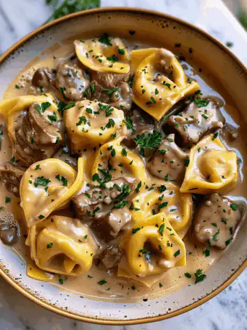 Buttery Steak Tortellini in Slow-Cooked Southern Garlic Cream Recipe taken with iphone 15 pro max --iw 2 --ar 4:5 --v 6.0 --raw