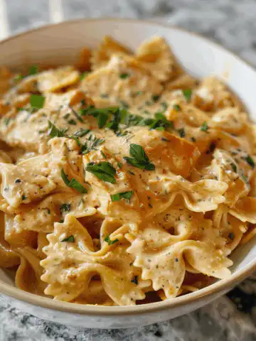 Creamy Cajun Chicken Bowtie Pasta with Garlic Cheese Sauce taken with iphone 15 pro max --iw 2 --ar 4:5 --v 6.0 --raw