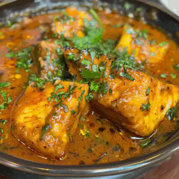 Indian Fish Curry taken with iphone 15 pro max --iw 2 --ar 4:5 --v 6.0 --raw