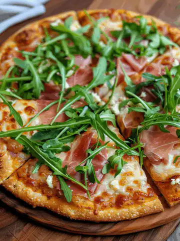Pumpkin Pizza Crust with Arugula and Prosciutto taken with iphone 15 pro max --iw 2 --ar 4:5 --v 6.0 --raw