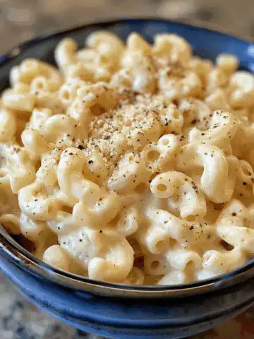 Irresistibly Creamy Stovetop Macaroni and Cheese taken with iphone 15 pro max --iw 2 --ar 4:5 --v 6.0 --raw
