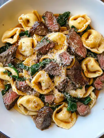 Garlic Steak Tortellini Recipe taken with iphone 15 pro max --iw 2 --ar 4:5 --v 6.1 --raw
